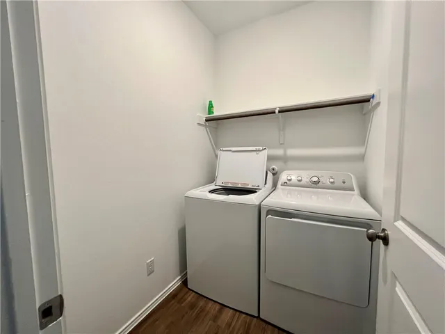a view of kitchen with stainless steel appliances granite countertop a stove a sink a refrigerator and a microwave