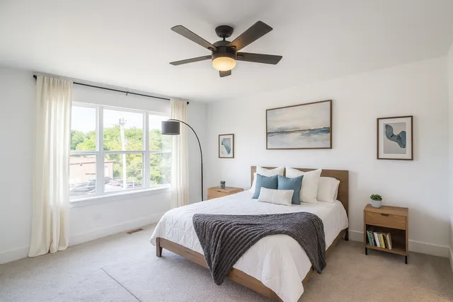 a bedroom with a bed and window