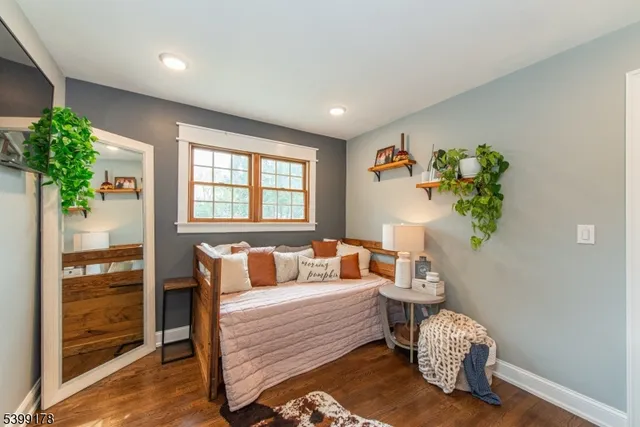 a bedroom with furniture and a potted plant