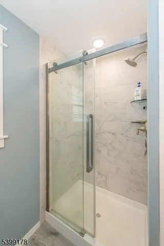a bathroom with a glass shower door