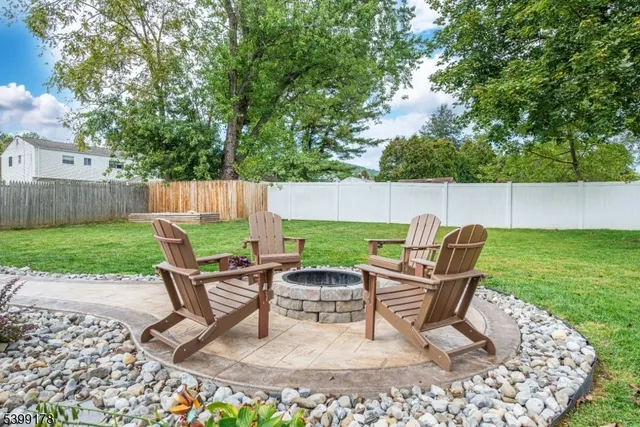 a view of a backyard with furniture and a garden