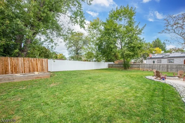 a view of a chairs and tables in the backyard of the house