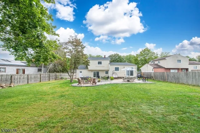 a view of a house with backyard and sitting area