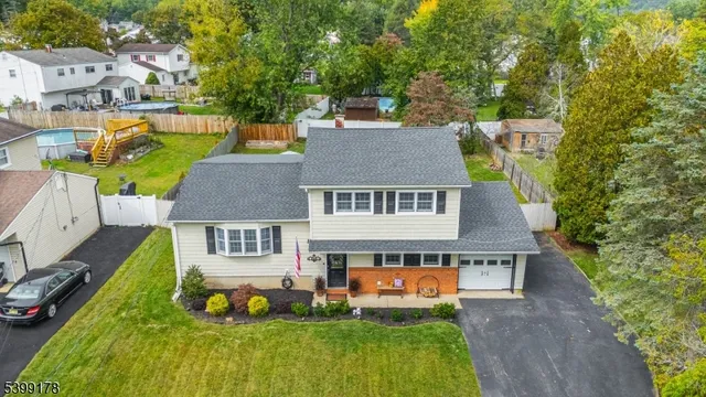 an aerial view of residential houses with outdoor space and swimming pool