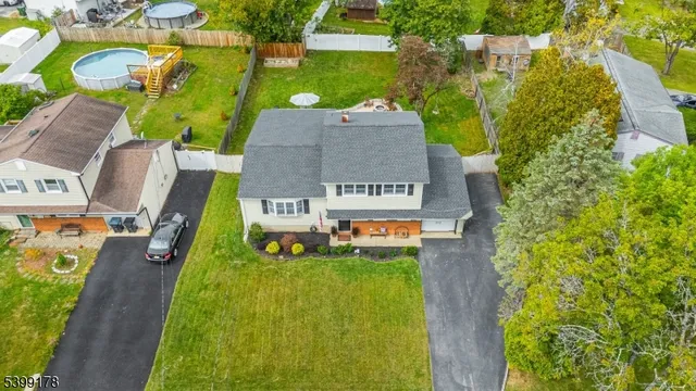 an aerial view of a house with a garden and swimming pool
