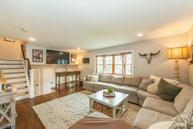 a living room with furniture and wooden floor