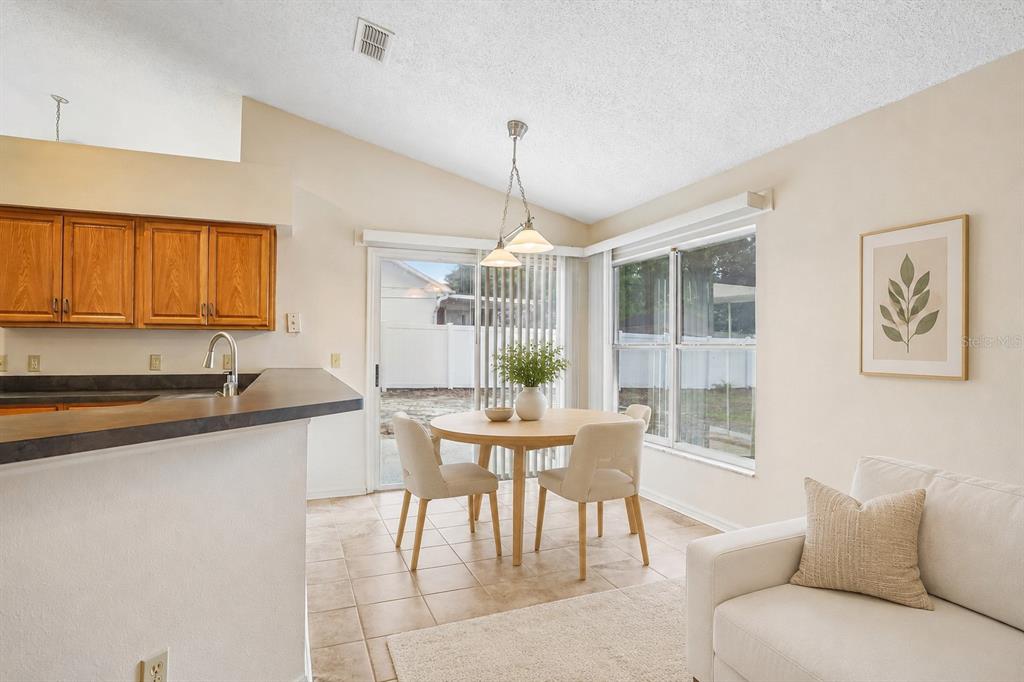 2596 Alclobe Circle Ocoee, FL 34761 - Photo 26 of 70 a dining room with furniture a chandelier and window