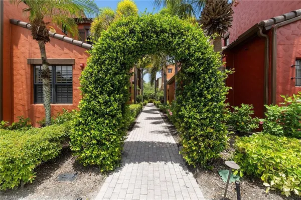 a front view of a house with a yard and fountain