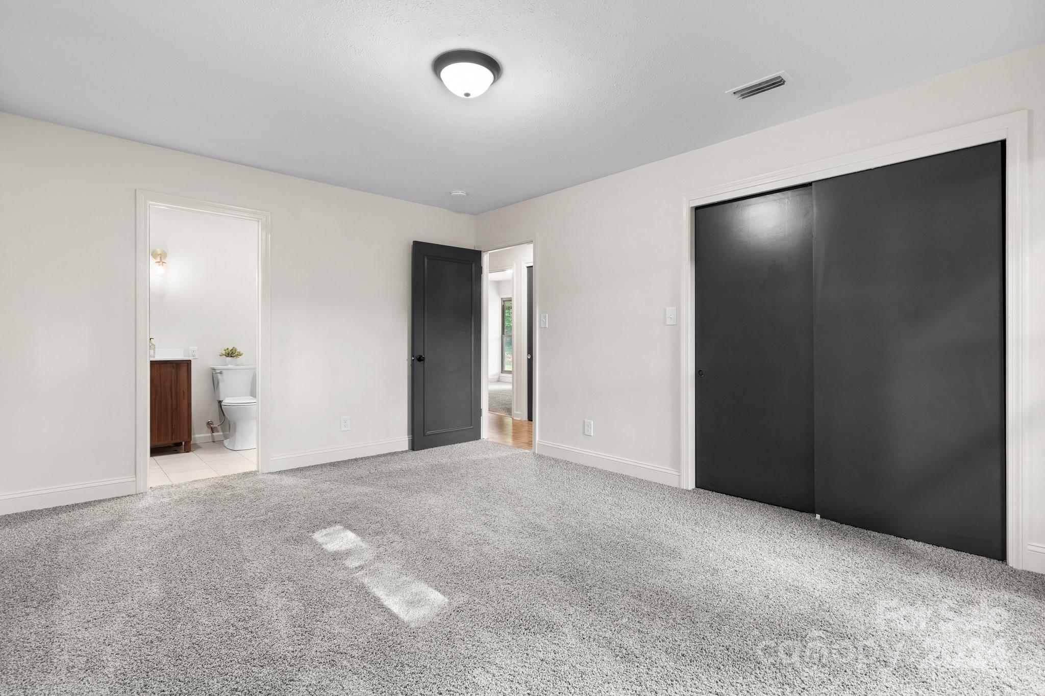 215 Blanton Road Morganton, NC 28655 - Photo 17 of 40 an empty room with closet and mirror