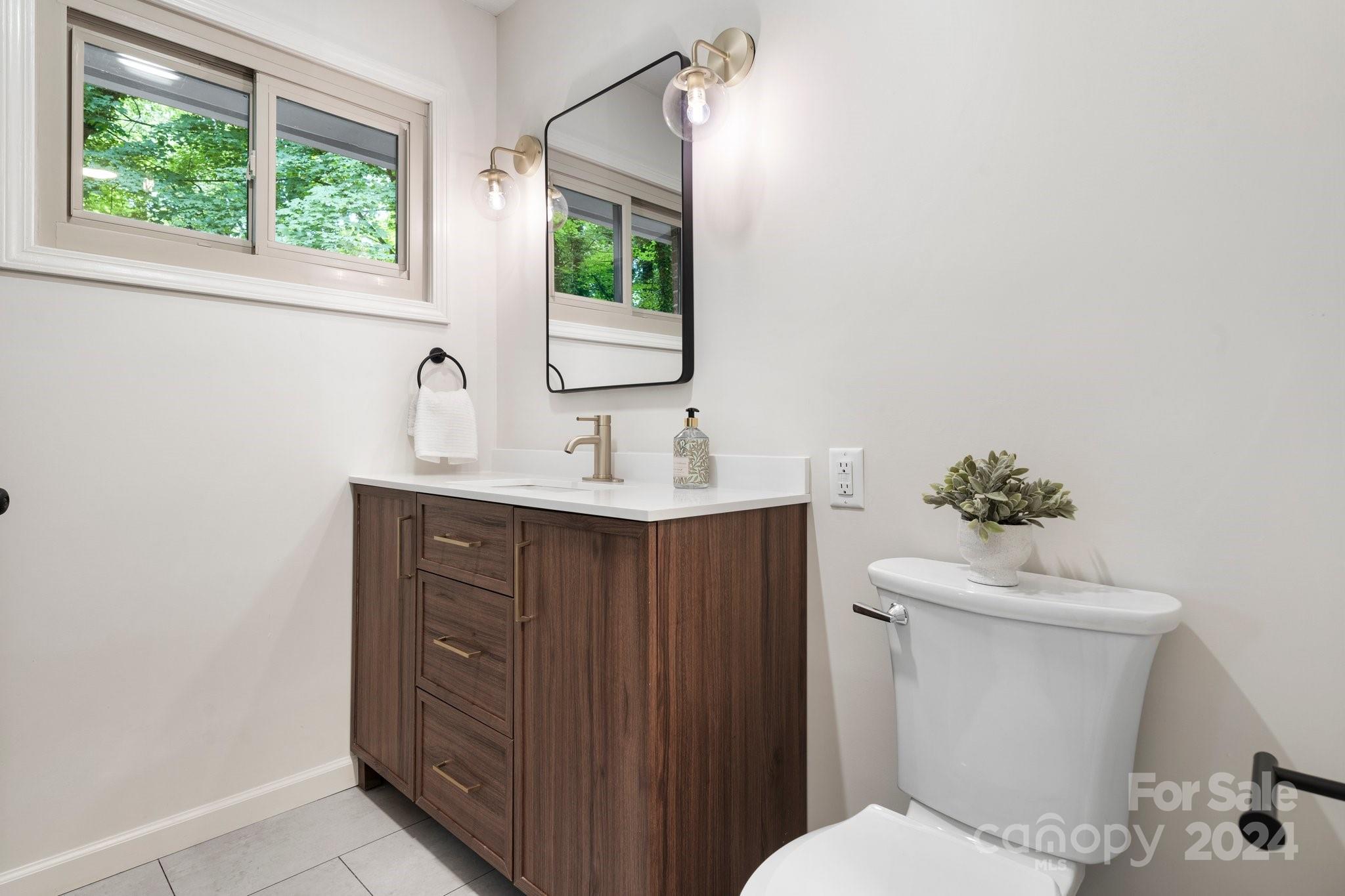 215 Blanton Road Morganton, NC 28655 - Photo 18 of 40 a bathroom with a sink vanity mirror and toilet
