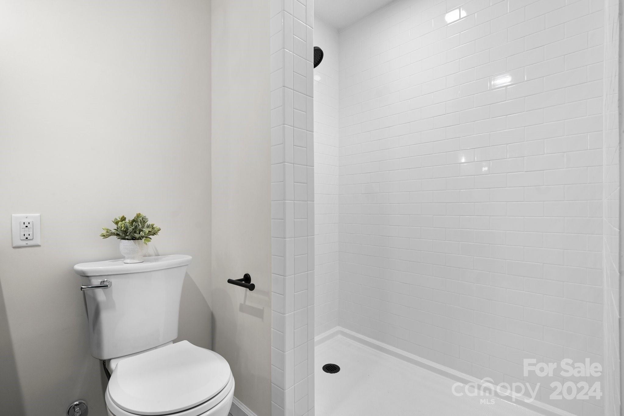 215 Blanton Road Morganton, NC 28655 - Photo 19 of 40 a white toilet sitting next to a shower