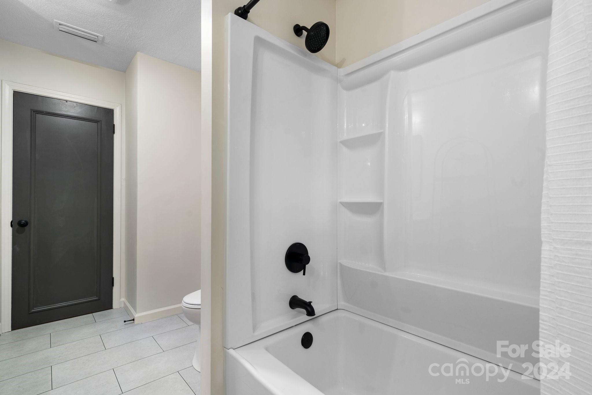 215 Blanton Road Morganton, NC 28655 - Photo 22 of 40 a bathroom with a tub and shower