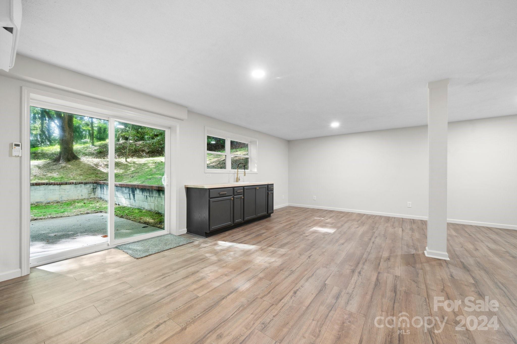 215 Blanton Road Morganton, NC 28655 - Photo 23 of 40 a view of an empty room with wooden floor and a window