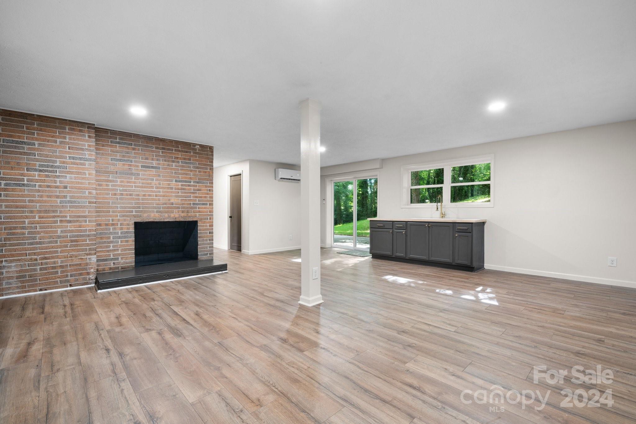 215 Blanton Road Morganton, NC 28655 - Photo 25 of 40 an empty room with wooden floor and fireplace