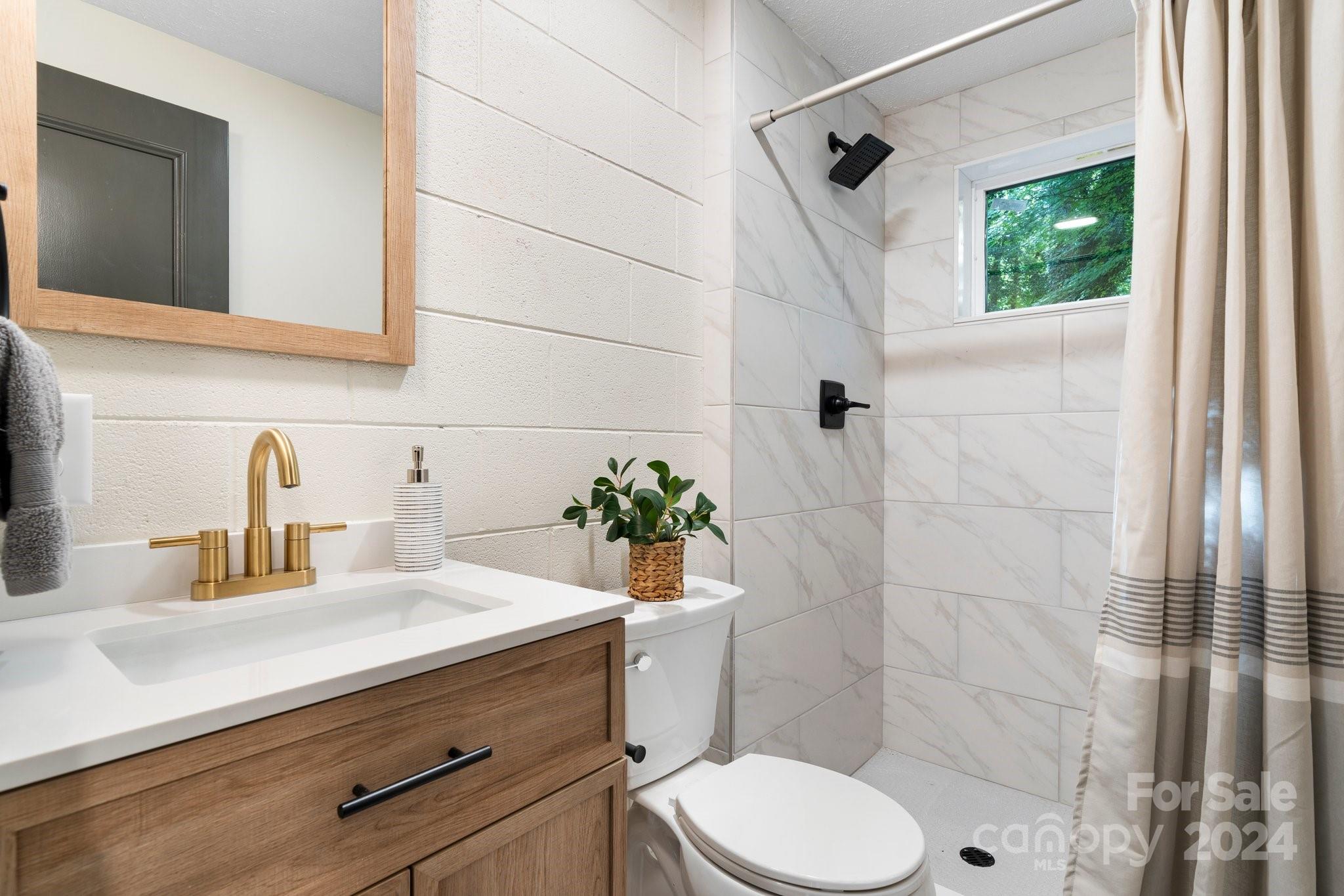215 Blanton Road Morganton, NC 28655 - Photo 28 of 40 a bathroom with a sink a toilet and shower