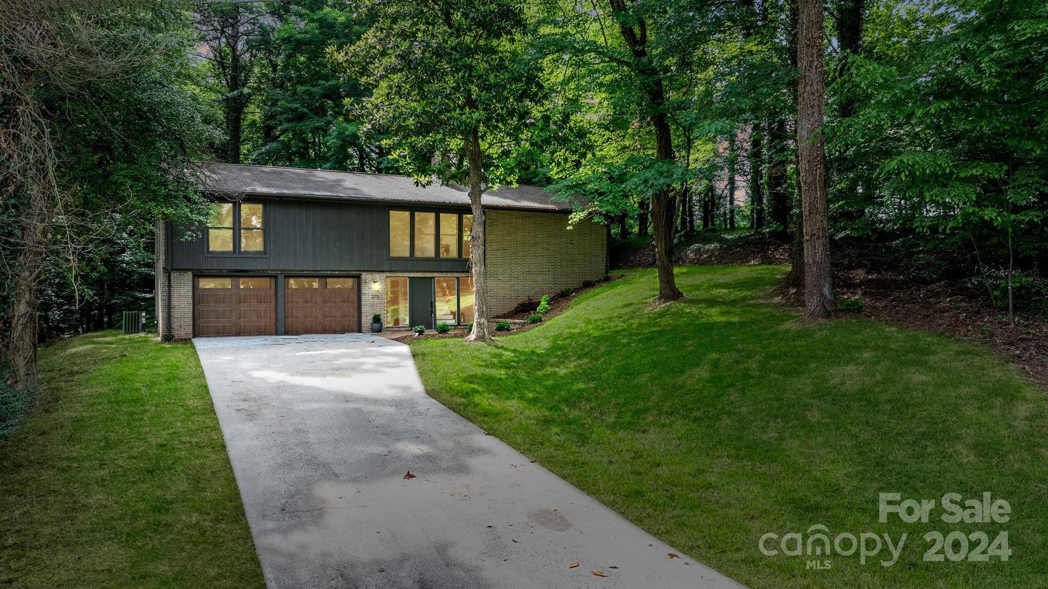 215 Blanton Road Morganton, NC 28655 - Photo 37 of 40 a front view of a house with a yard and trees