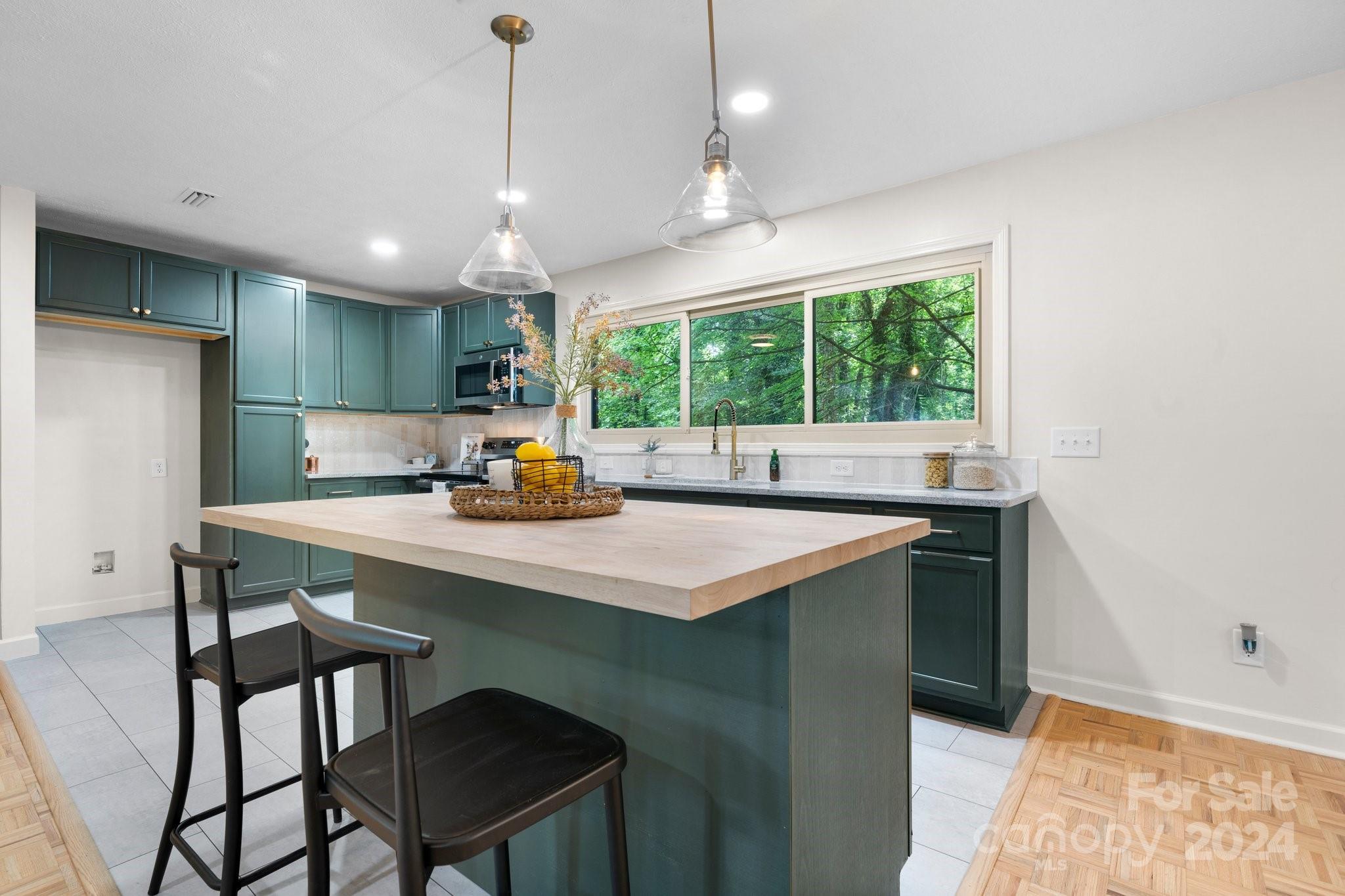 215 Blanton Road Morganton, NC 28655 - Photo 8 of 40 a kitchen with a sink a counter top space and appliances