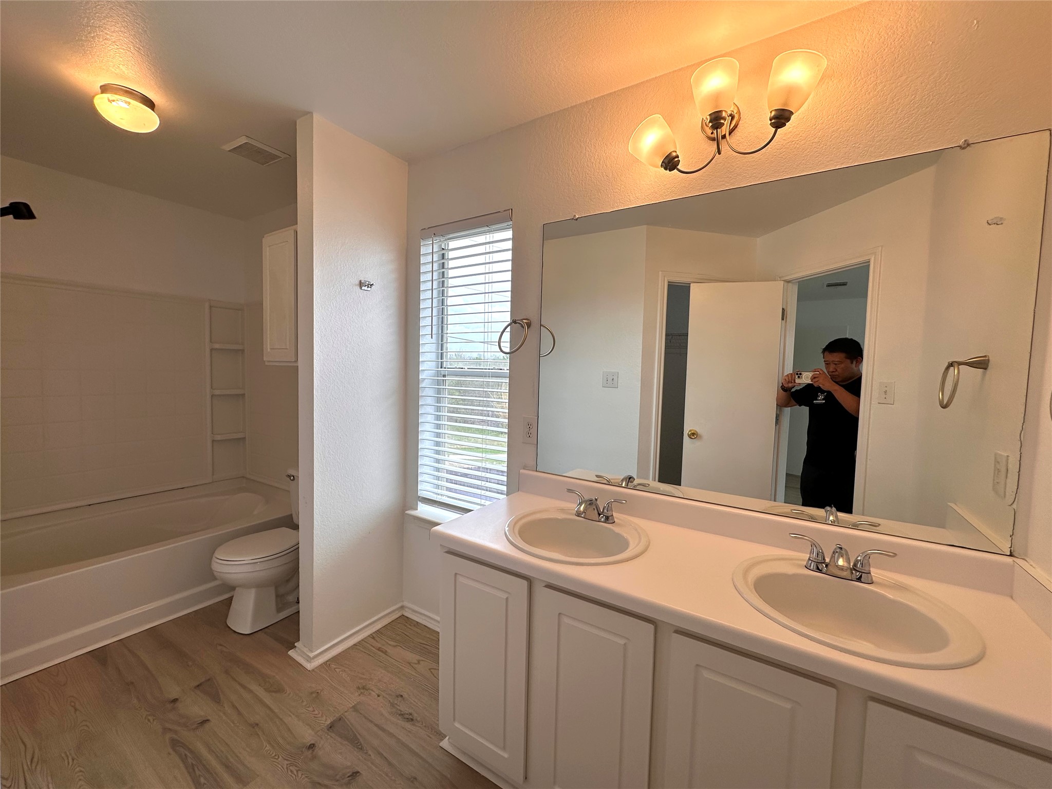 722 Lavaca Loop Elgin, TX 78621 - Photo 13 of 24 a bathroom with a double vanity sink toilet and shower