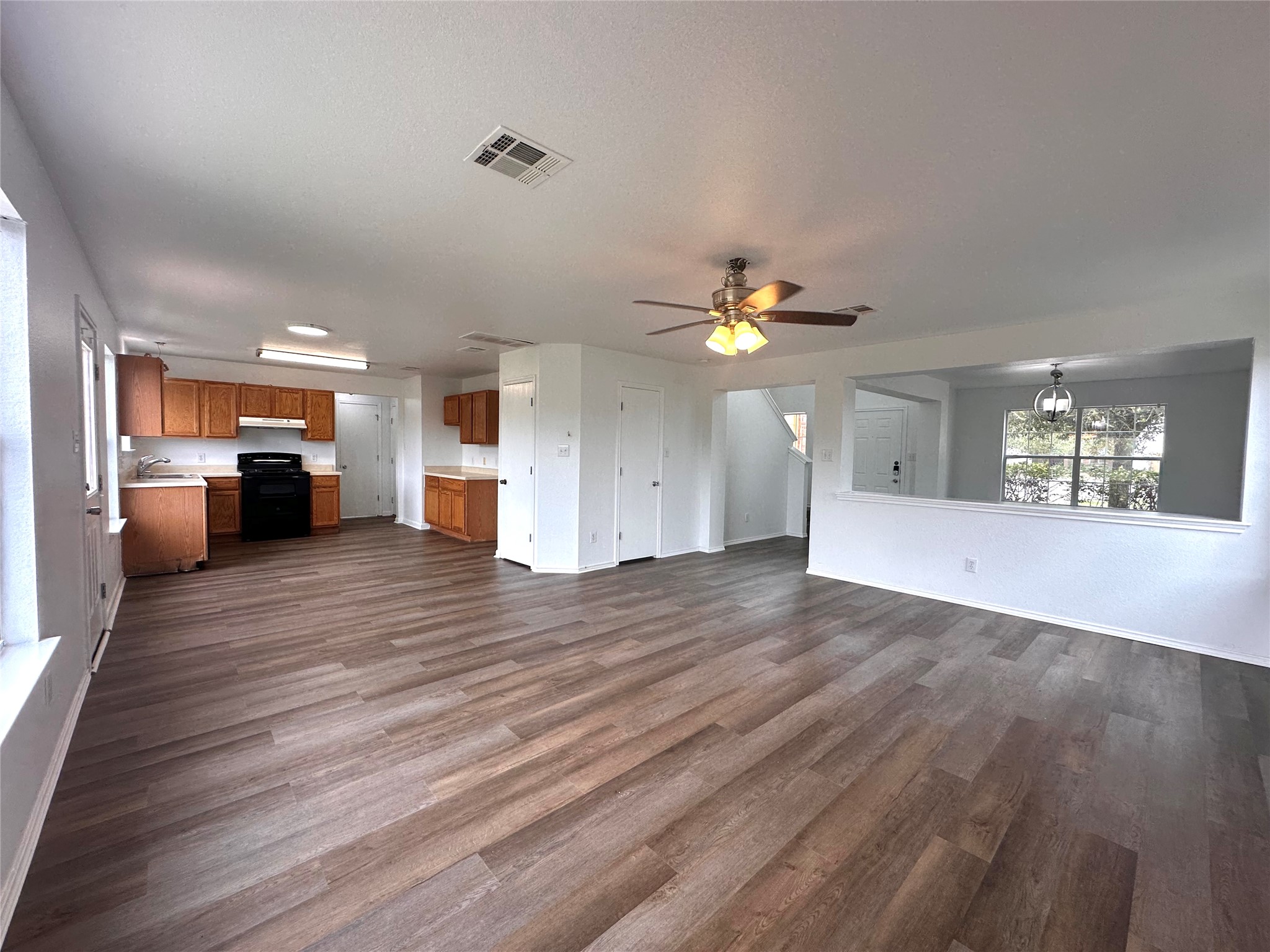 722 Lavaca Loop Elgin, TX 78621 - Photo 5 of 24 a view of an empty room with window and wooden floor