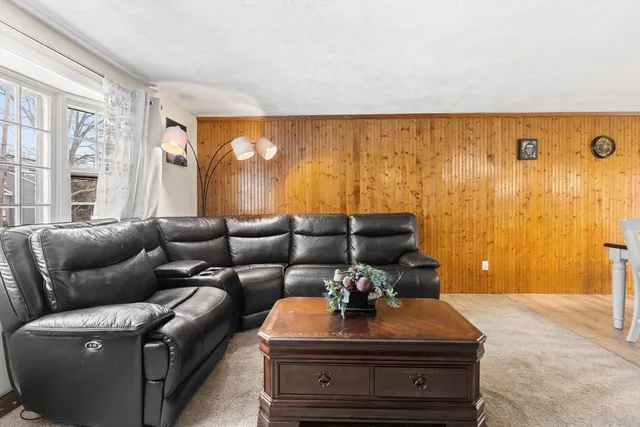 a living room with furniture and a lamp