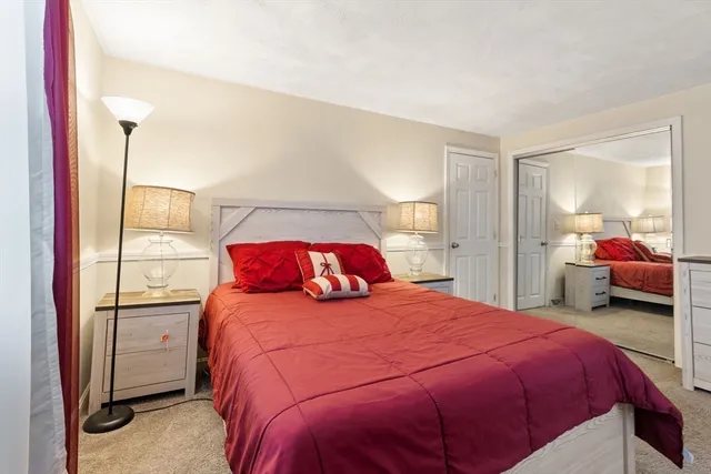 a bedroom with a bed and a large mirror