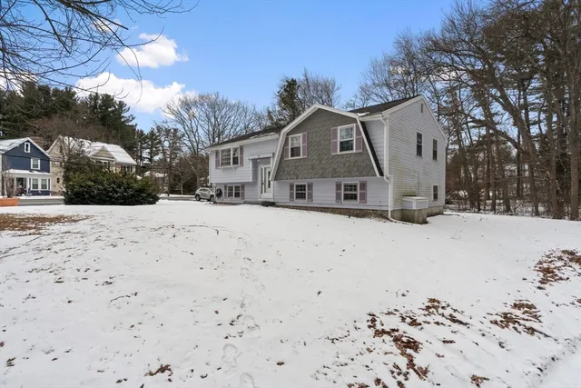 a view of a house with snow on the road