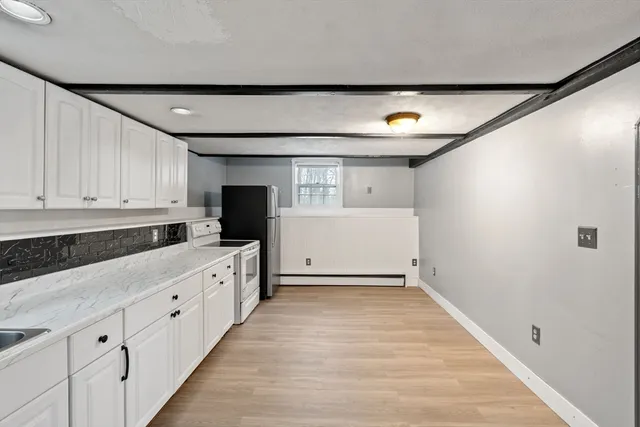 a view of a kitchen with electric appliances