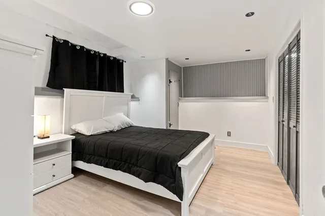 a bedroom with a bed and a night stand