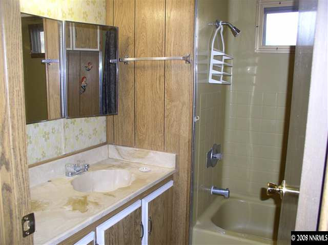 225 Aries Circle Reno, NV 89521 - Photo 5 of 9 a bathroom with a granite countertop tub sink and mirror