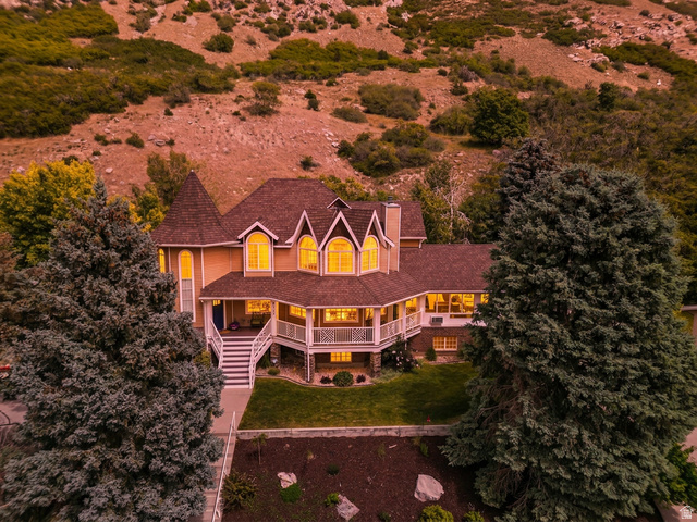 Grand residence featuring a prominent turret and multiple gabled dormers