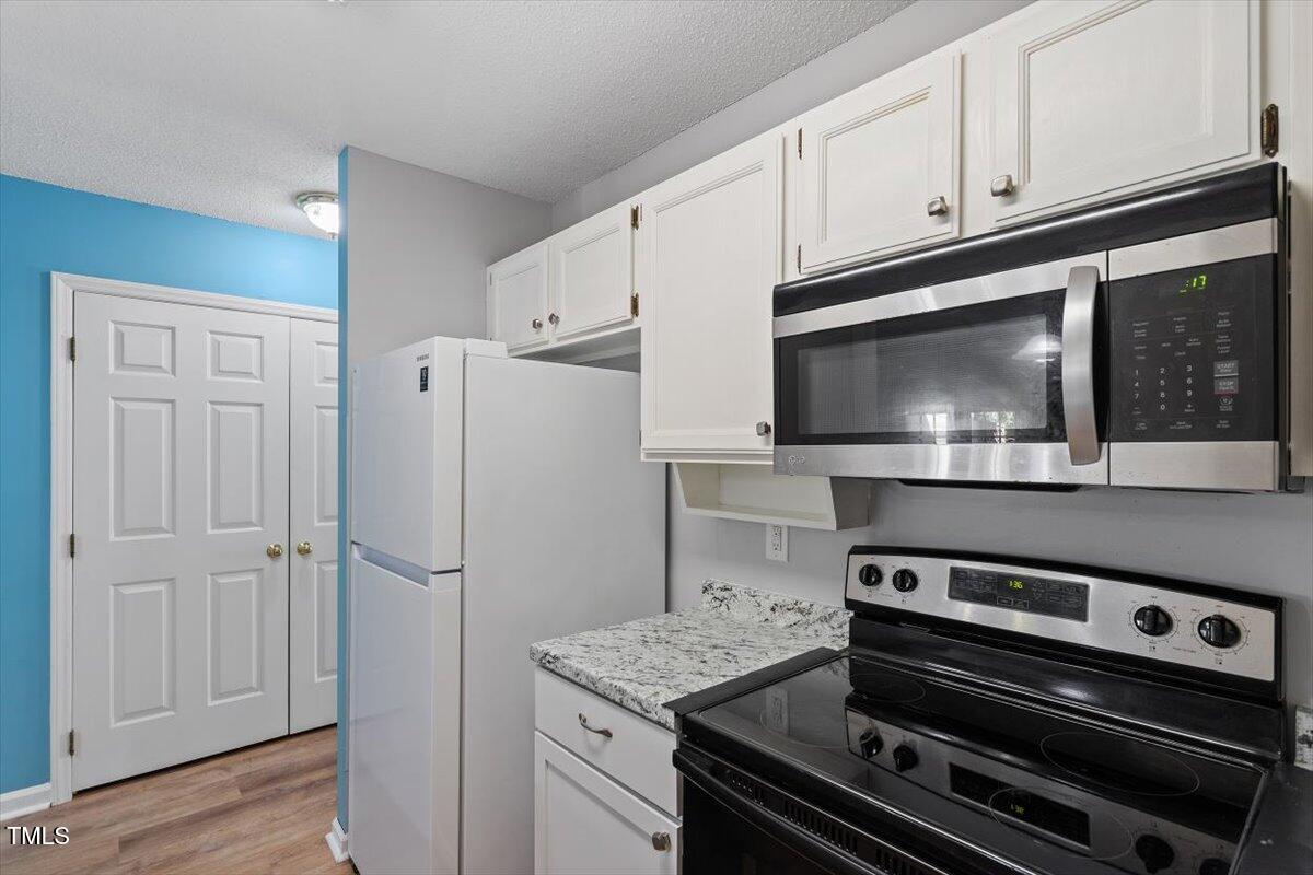 69 Forest Oaks Drive Durham, NC 27705 - Photo 12 of 31 a kitchen with a stove and a microwave