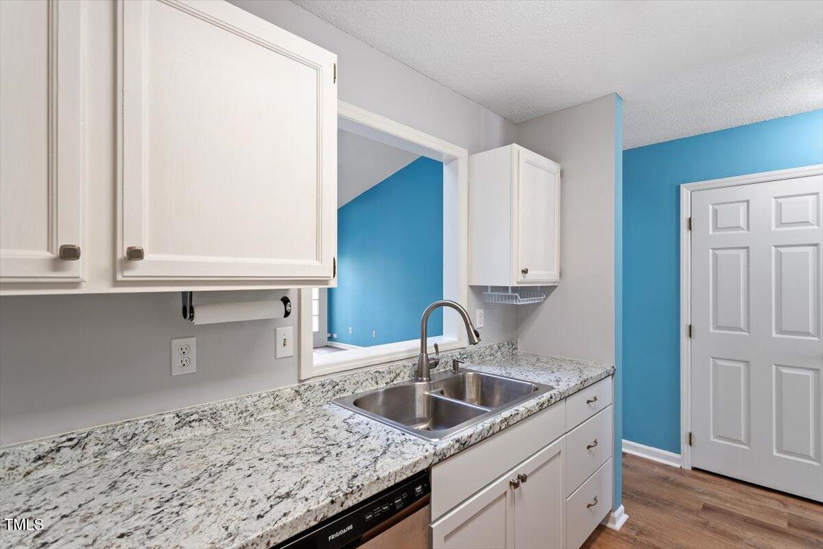 69 Forest Oaks Drive Durham, NC 27705 - Photo 13 of 31 a kitchen with stainless steel appliances granite countertop a sink and a white cabinets