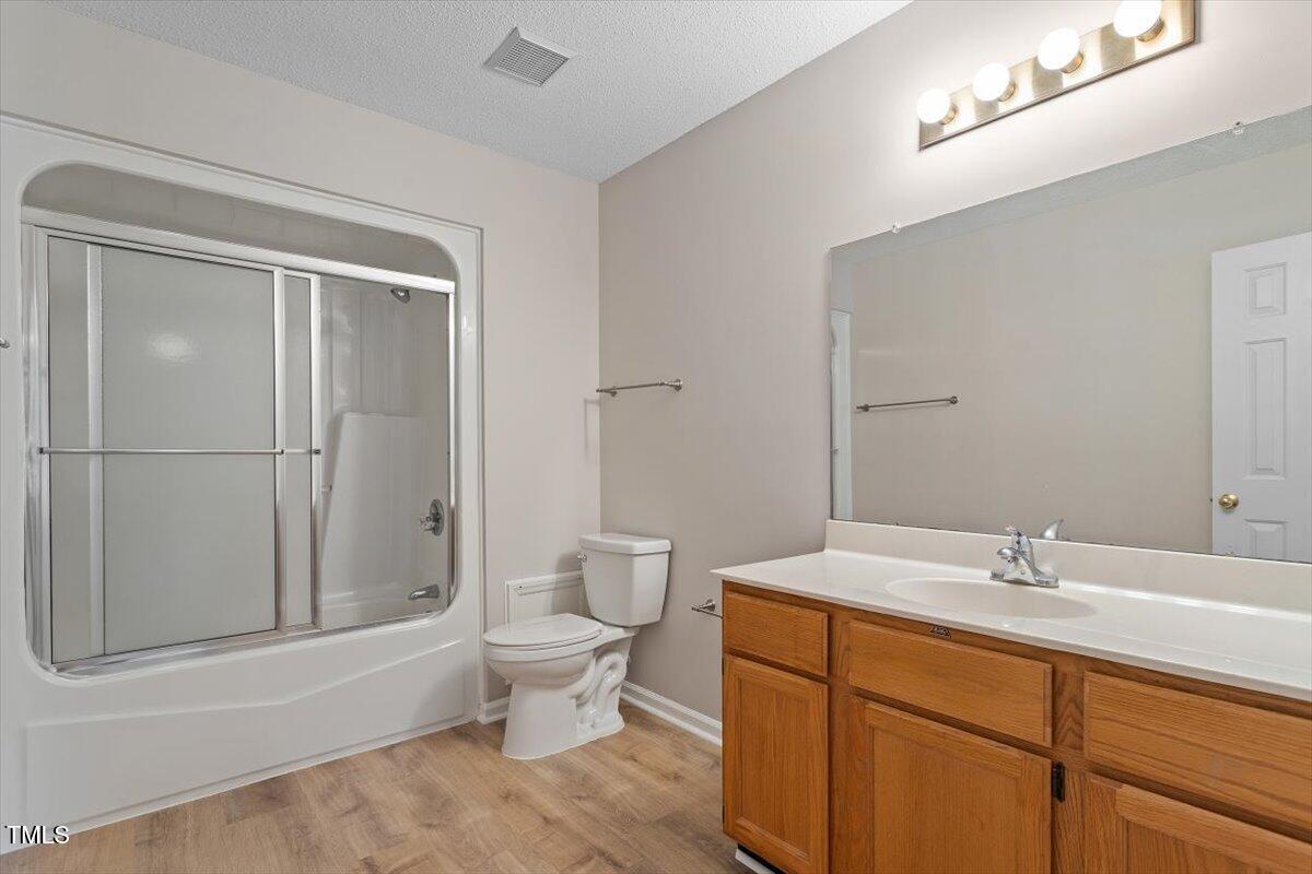 69 Forest Oaks Drive Durham, NC 27705 - Photo 16 of 31 a bathroom with a sink a toilet and shower