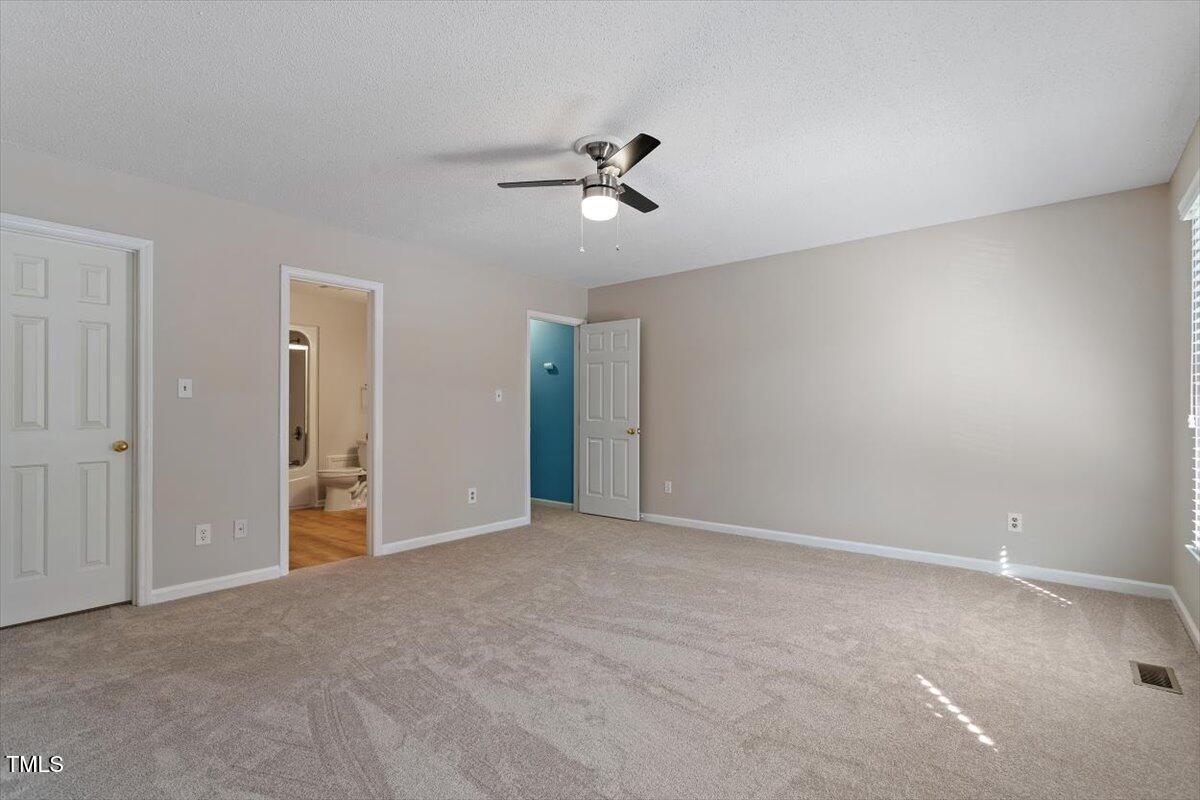 69 Forest Oaks Drive Durham, NC 27705 - Photo 18 of 31 a view of an empty room with a ceiling fan