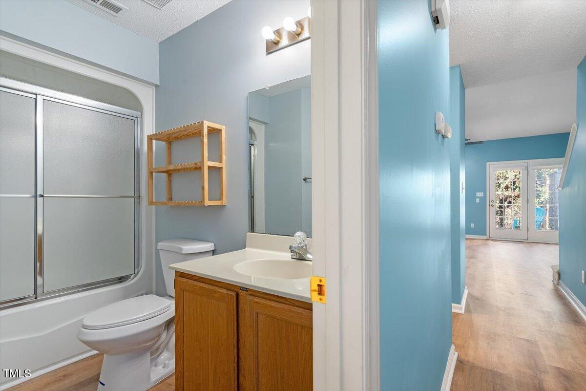 69 Forest Oaks Drive Durham, NC 27705 - Photo 20 of 31 a bathroom with a sink a toilet and shower
