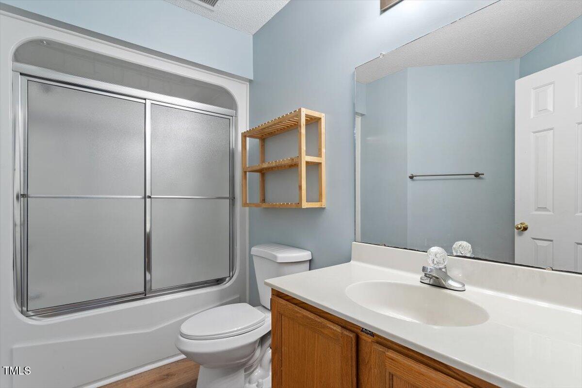 69 Forest Oaks Drive Durham, NC 27705 - Photo 21 of 31 a bathroom with a sink toilet and mirror