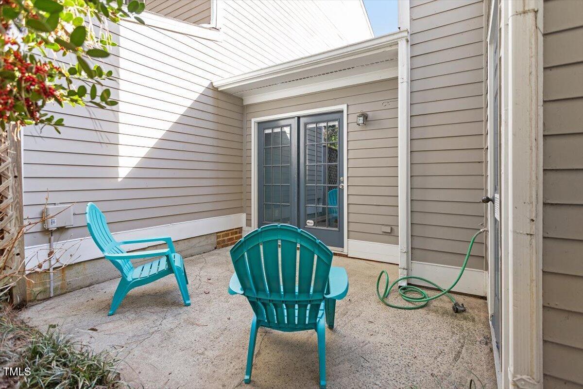 69 Forest Oaks Drive Durham, NC 27705 - Photo 25 of 31 a view of a chair and table in backyard