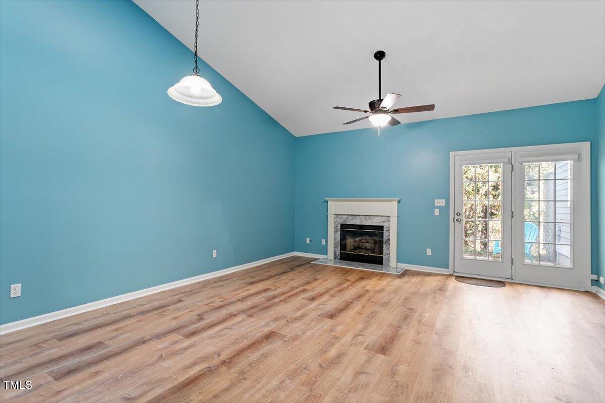 69 Forest Oaks Drive Durham, NC 27705 - Photo 5 of 31 a view of an empty room with a fireplace and a window