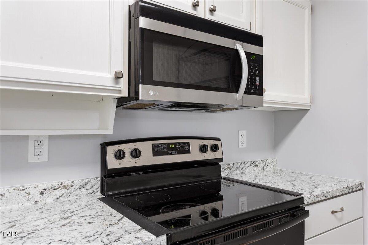 69 Forest Oaks Drive Durham, NC 27705 - Photo 9 of 31 a kitchen with a stove and a microwave