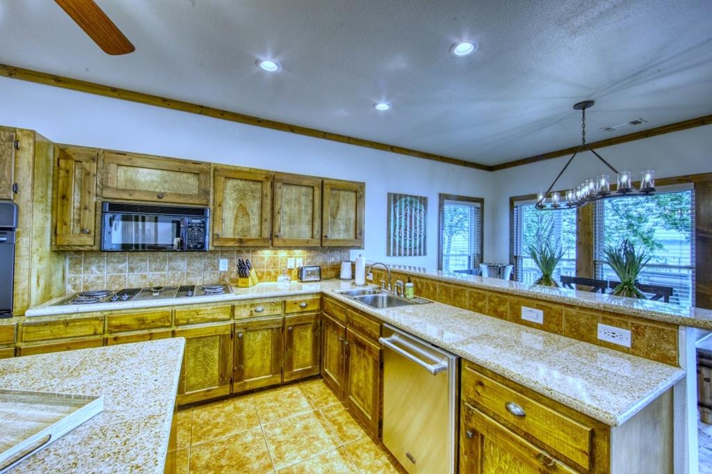 6207 Point Lavista Malakoff, TX 75148 - Photo 11 of 40 a large kitchen with a lot of counter space and a wooden floor
