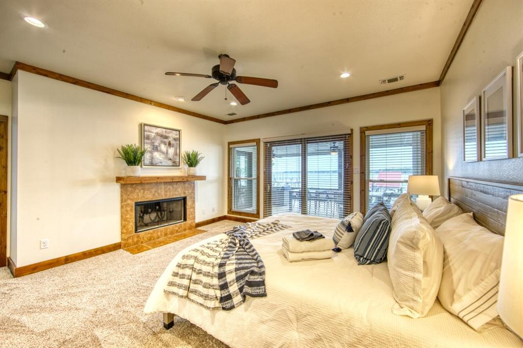 6207 Point Lavista Malakoff, TX 75148 - Photo 13 of 40 a bed sitting in a spacious bedroom next to a fireplace