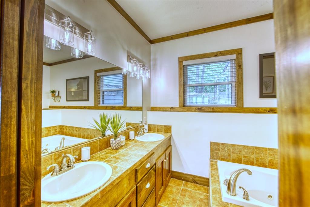6207 Point Lavista Malakoff, TX 75148 - Photo 15 of 40 a bathroom with a granite countertop sink and a mirror