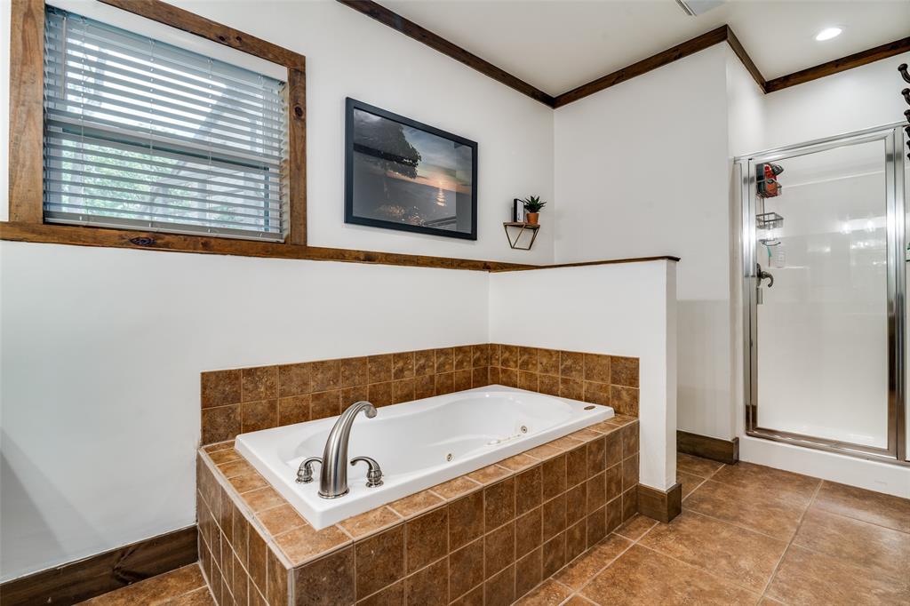 6207 Point Lavista Malakoff, TX 75148 - Photo 15 of 40 a bathroom with a tub and a shower