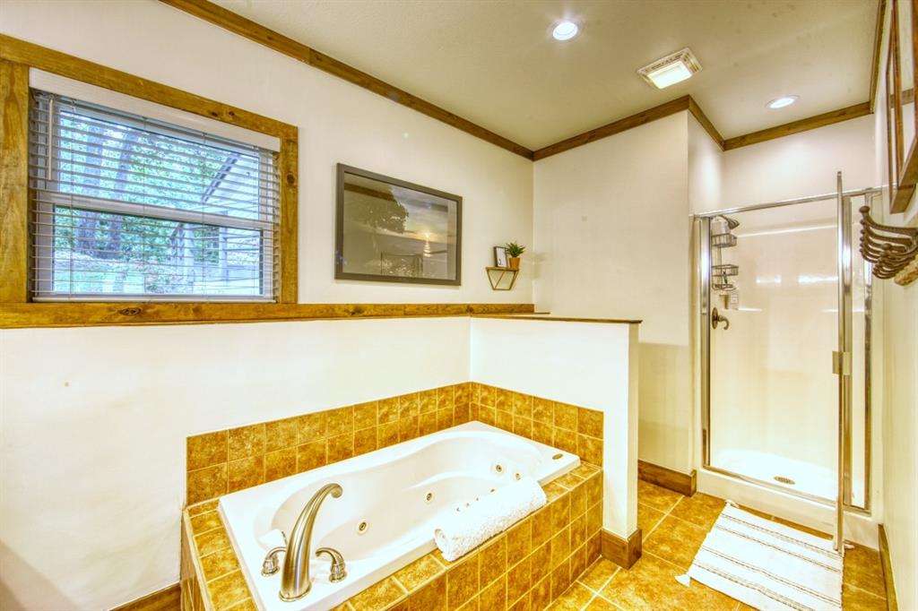 6207 Point Lavista Malakoff, TX 75148 - Photo 16 of 40 a bathroom with a tub and a shower