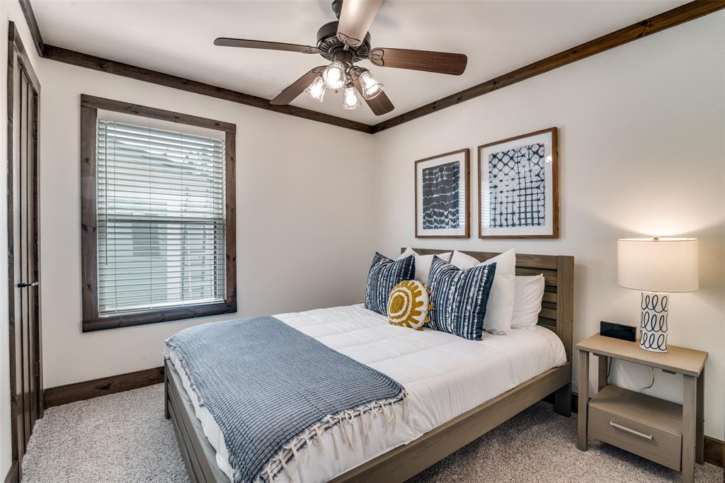 6207 Point Lavista Malakoff, TX 75148 - Photo 22 of 40 a bedroom with a bed and a chandelier