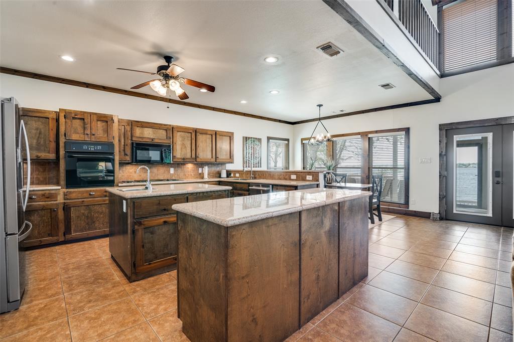 6207 Point Lavista Malakoff, TX 75148 - Photo 8 of 40 a kitchen with stainless steel appliances granite countertop a sink and cabinets