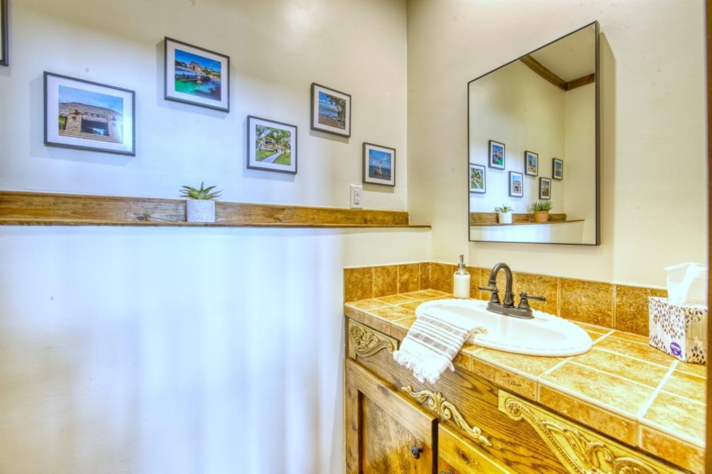 6207 Point Lavista Malakoff, TX 75148 - Photo 10 of 40 a bathroom with a sink and a mirror