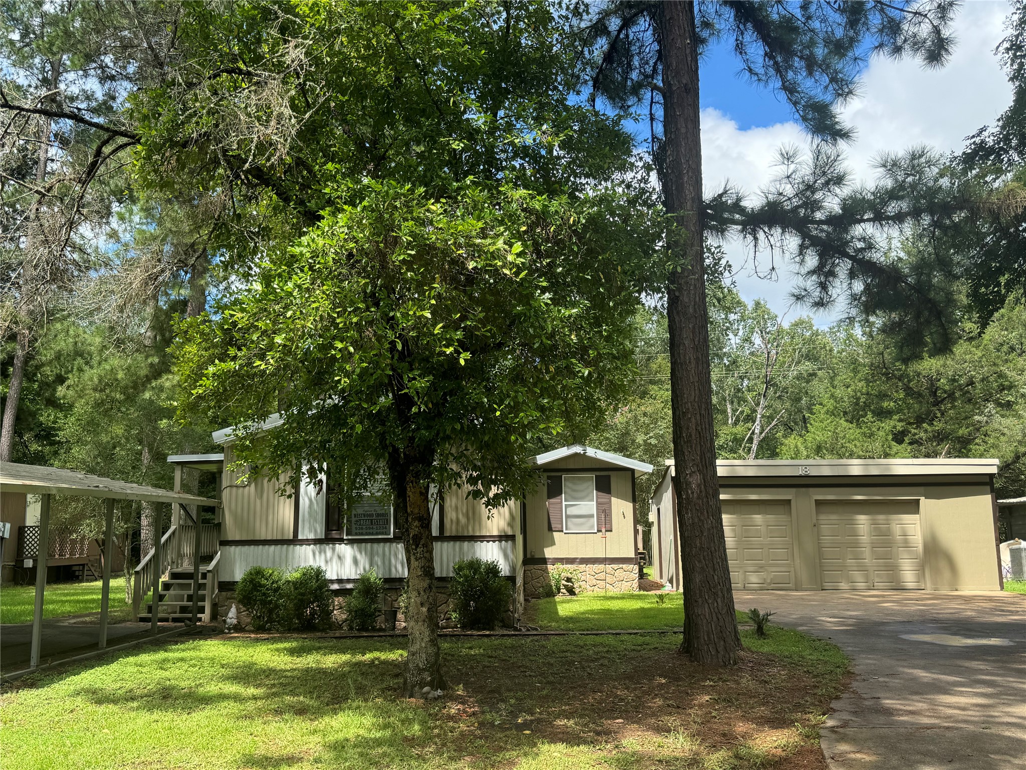 a view of a house with backyard and a tree