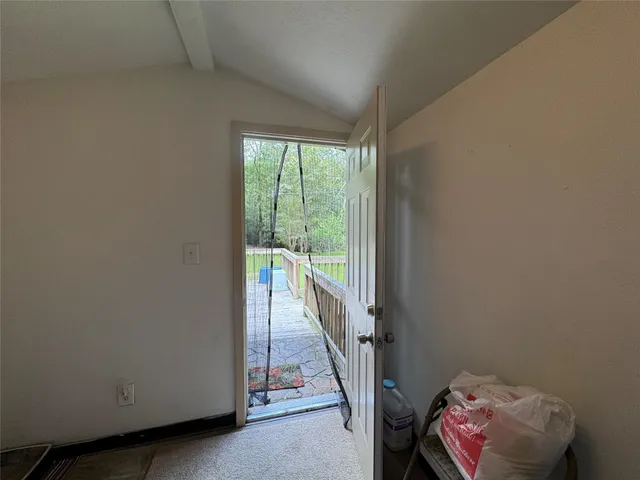 a view of hallway with furniture and a floor to ceiling window