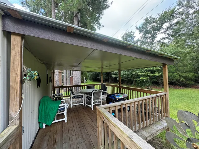 an outdoor view of garden with deck having patio